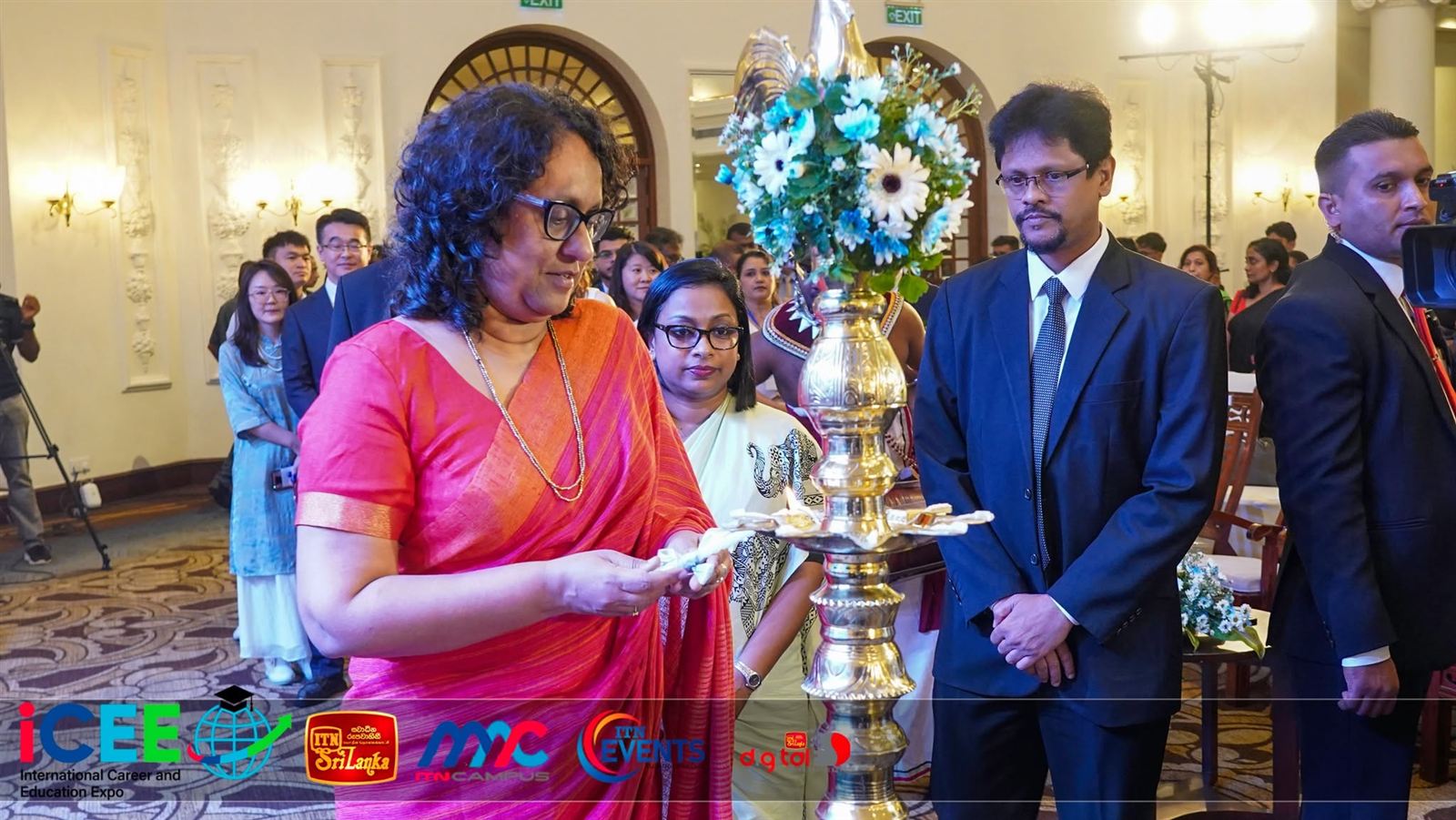 The Prime Minister lights the traditional oil lamp.